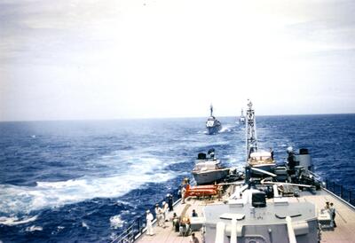 USS Worcester with other ships following
